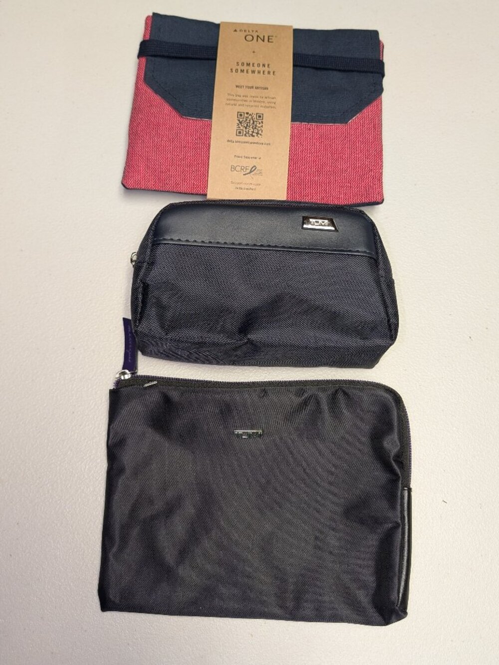 Set of three Tumi first class amenity kits